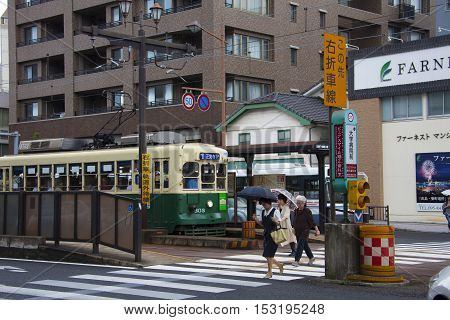 Nagasaki, Japan - August 19, 2015 Cars And Vintage Tram On The Road