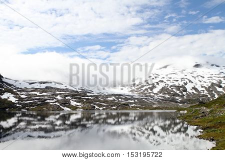 Landscape with snow mountain lake and reflection Norway