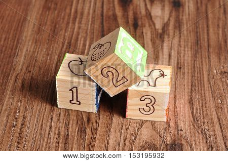 Alphabet blocks 123 isolated on a wooden background