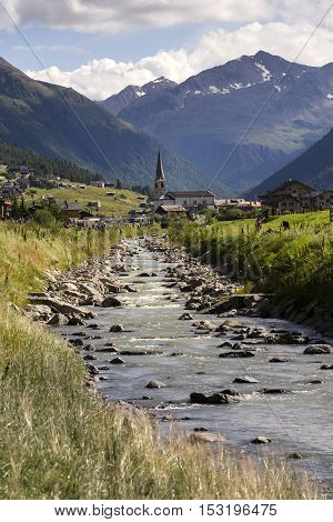 Spol River With Church Of Santa Maria In Livigno, Italy