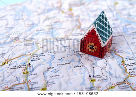 little toy house on the map. concept of travel rent abroad. a family holiday on lodgy term. holiday