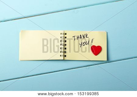 Thank You A spiral Notepad that has the words Thank You wooden red heart over a distressed wood turquoise background. Valentine's Day