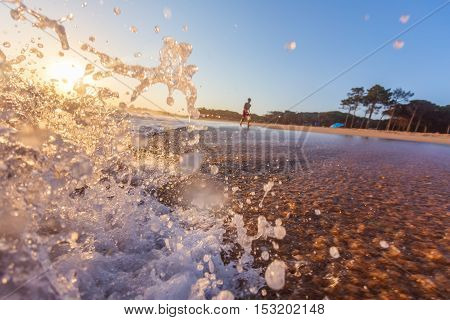 Blue Ocean Wave Crashing at Sunrise. In Portugal.