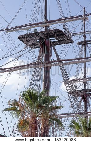 foreground of mast and crows nest of a ship with sky in the background