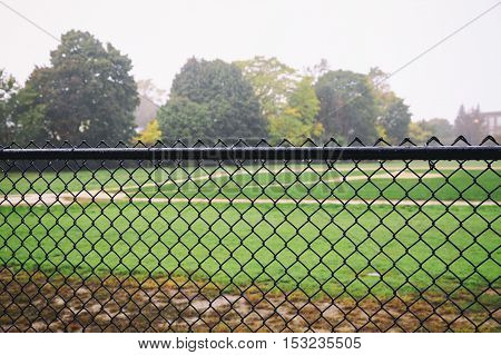 rain on an empty sports field. the concept of the abolition of the sports games or training due to bad weather