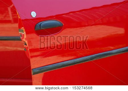 Red car open door detail with the lock