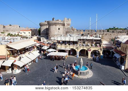 Rhodes, Greece - October 18, 2016: View of Rhodes old city center  square with restaurants and fountain, the old city of Rhodes is surrounded by aincent walls.