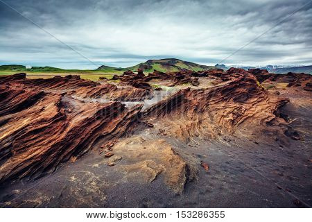 Sandy rocks with by magma formed by winds. Popular tourist attraction. Unusual and gorgeous scene. Location Sudurland, cape Dyrholaey, south coast of Iceland, Europe. Artistic picture. Beauty world.