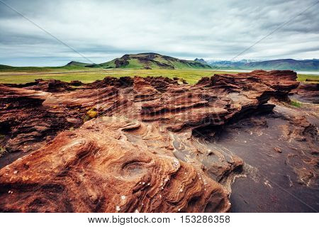 Sandy rocks with by magma formed by winds. Popular tourist attraction. Unusual and gorgeous scene. Location Sudurland, cape Dyrholaey, south coast of Iceland, Europe. Artistic picture. Beauty world.