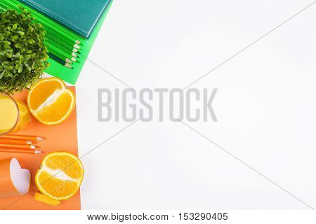 White desk with orange halves supplies decorative plants and copy space. Mock up