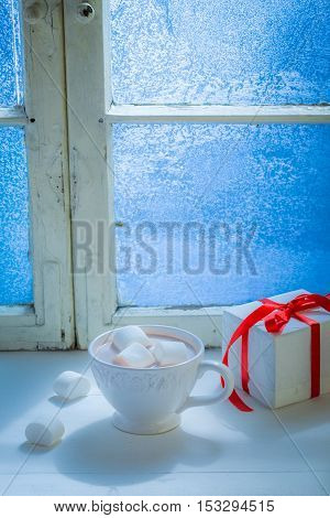 Homemade Christmas chocolate with marshmallows in cold evening