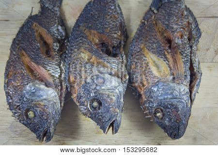 Three fish body fry on Chopping Wood and asian food.