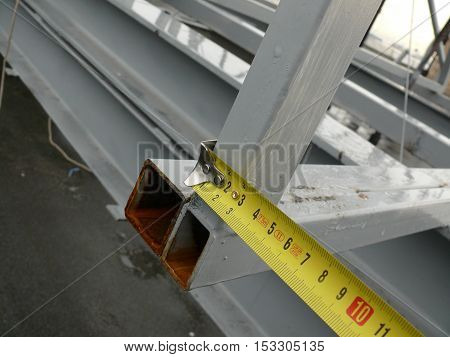 measurement of the dimensions of metal structures on the roof.