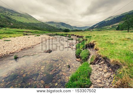 River and mountain in a foggy day in Scotland