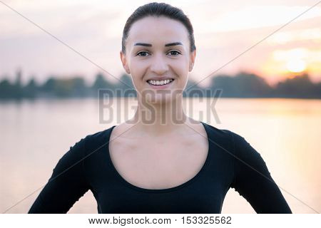 Young Woman Portrait In Early Morning At Sunrise Background