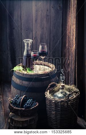 Fresh Homemade Wine In Glass With Grapes And Demijohn