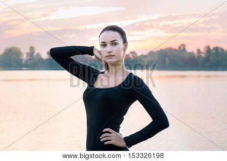 Young Woman Portrait In Early Morning At Colorful Sunrise
