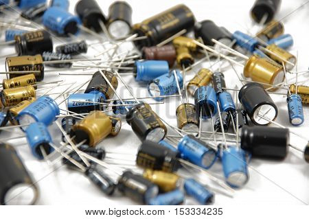 Lots of different capacitors on white background