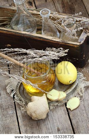 Still life with gingerlemonhoney and Provencal herbs on a wooden table