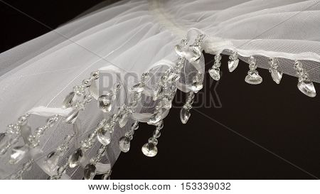 Closeup on the part of the white curtainsider with dangling crystals