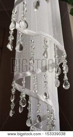 Closeup on the part of the white curtainsider with dangling crystals