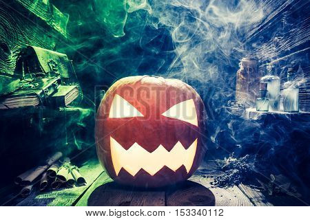 Scary Halloween Pumpkin With Blue And Green Smoke In Witcher Hut