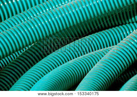 Green plastic pvc  ppr pipes hose for plumbing water fluids hydraulic sewage on the floor of construction site. background
