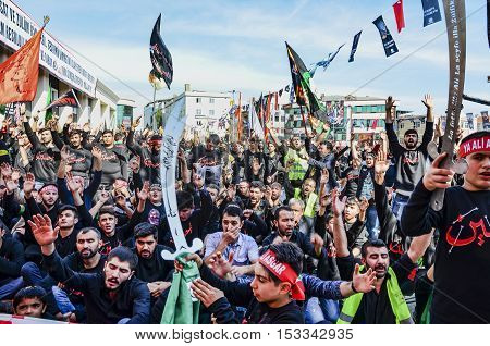 Istanbul Turkey - October 11 2016: Shia Muslim men shout Islamic slogans as they mourn during an Ashura procession. Turkish Shia Muslims mourning for Imam Hussain. Caferis take part in a mourning procession marking the day of Ashura in Istanbul's Kucukcek
