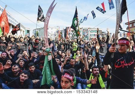 Istanbul Turkey - October 11 2016: Shia Muslim men shout Islamic slogans as they mourn during an Ashura procession. Turkish Shia Muslims mourning for Imam Hussain. Caferis take part in a mourning procession marking the day of Ashura in Istanbul's Kucukcek