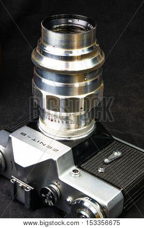 DONETSK, UKRAINE - May 07, 2016: old soviet film SLR camera Zenit - B with lens Jupiter-11, for use with 35 mm film, made in USSR in 1968 - 1973, manufactured by KMZ, with original leather case