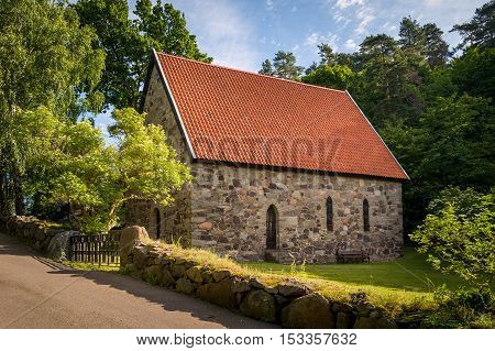 Lovoy old stone chapel on the spring's water source. Falkensten, Norway.
