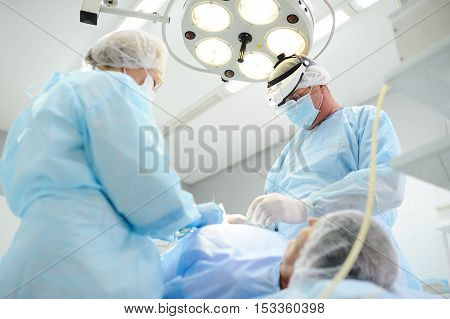 surgeons operate on a patient in the background Surgical Lamp