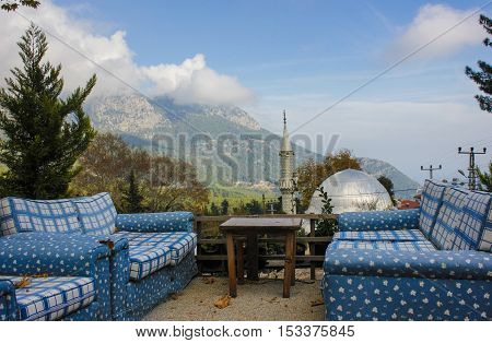 Blue sofas and table on mosques and mountain background in Turkey.