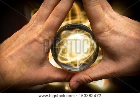 Holding atom in fortune teller magic crystal ball