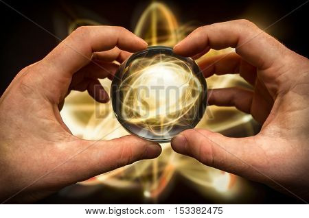 Holding atom in fortune teller magic crystal ball