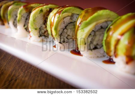 Eel avacado dragon roll with sushi bbq sauce
