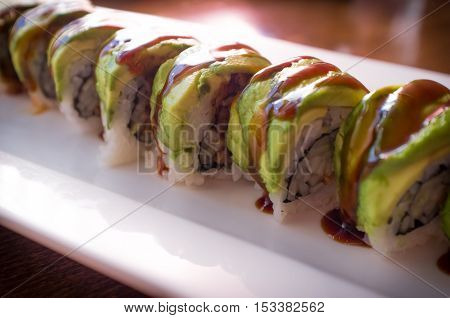 Eel avacado dragon roll with sushi bbq sauce