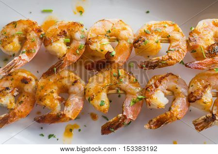 Fresh hot grilled jumbo shrimp kebabs with parsley
