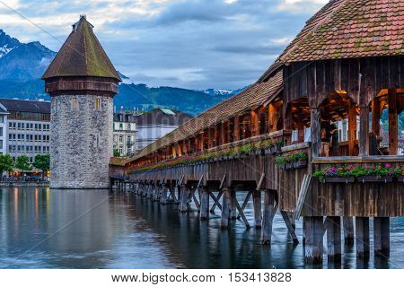 Night view towards Chapel Bridge (Kapellbruecke) together with the octagonal tall tower (Wasserturm) it is one of the Lucerne's most famous tourists attraction