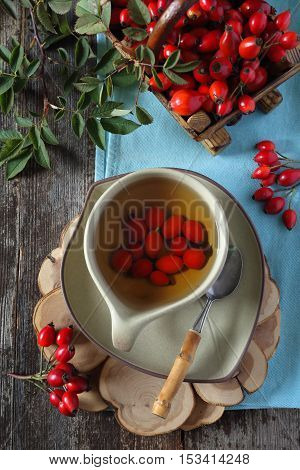 Rosehip tea and berries in basket top view