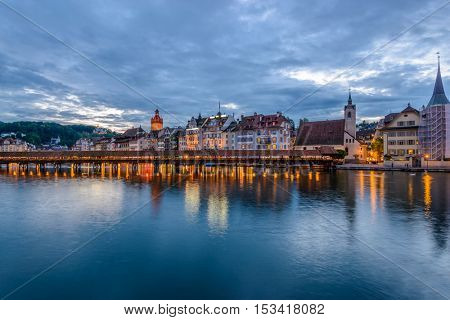 Night view towards Chapel Bridge (Kapellbruecke) together with the octagonal tall tower (Wasserturm) it is one of the Lucerne's most famous tourists attraction