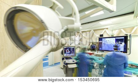 Laparoscopic heart surgery in a modern hospital with specialized equipment - scanners and monitors.