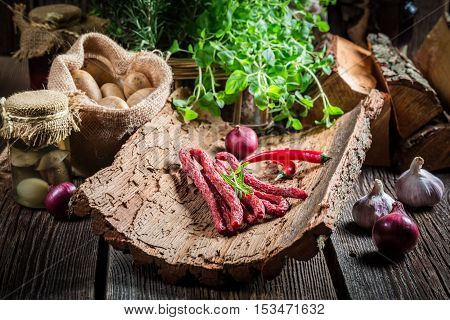 Homemade kabanos sausages in rural basement on old wooden table