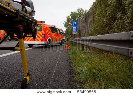 HANNOVER / GERMANY - OCTOBER 25 2016: Emergency stretcher stands with a german firefighting truck on freeway a2 by a truck crash near Hannover.