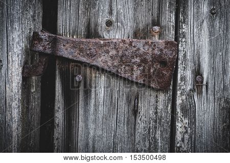 Old rusty hinge on a barn door