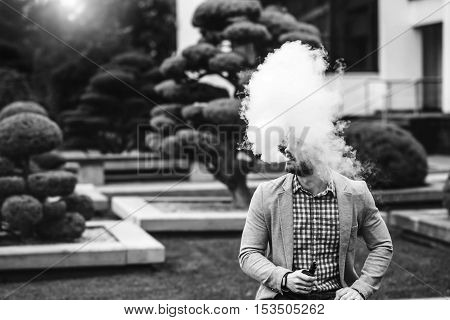 Men With Beard Smoking Electronic Cigarette Outdoor