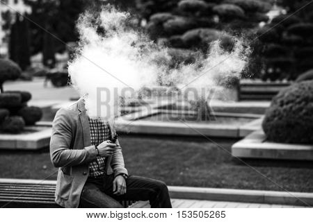 Men With Beard Vaping Electronic Cigarette Outdoor