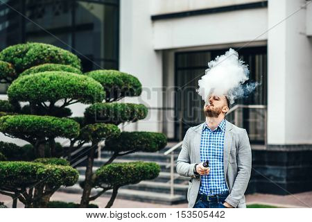 Men With Beard Smoking Electronic Cigarette Outdoor