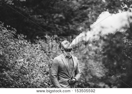 Men With Beard Smoking Electronic Cigarette Outdoor