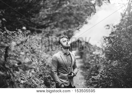 Men With Beard Smoking Electronic Cigarette Outdoor